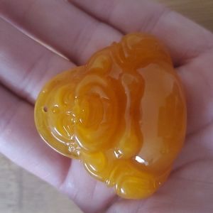 New Carved Man-Made Amber Buddha Unisex Pendant.